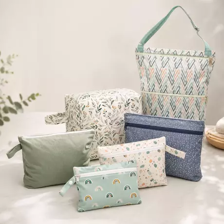 A range of printed cloth diaper wet bags in different types and sizes for a brand.webp